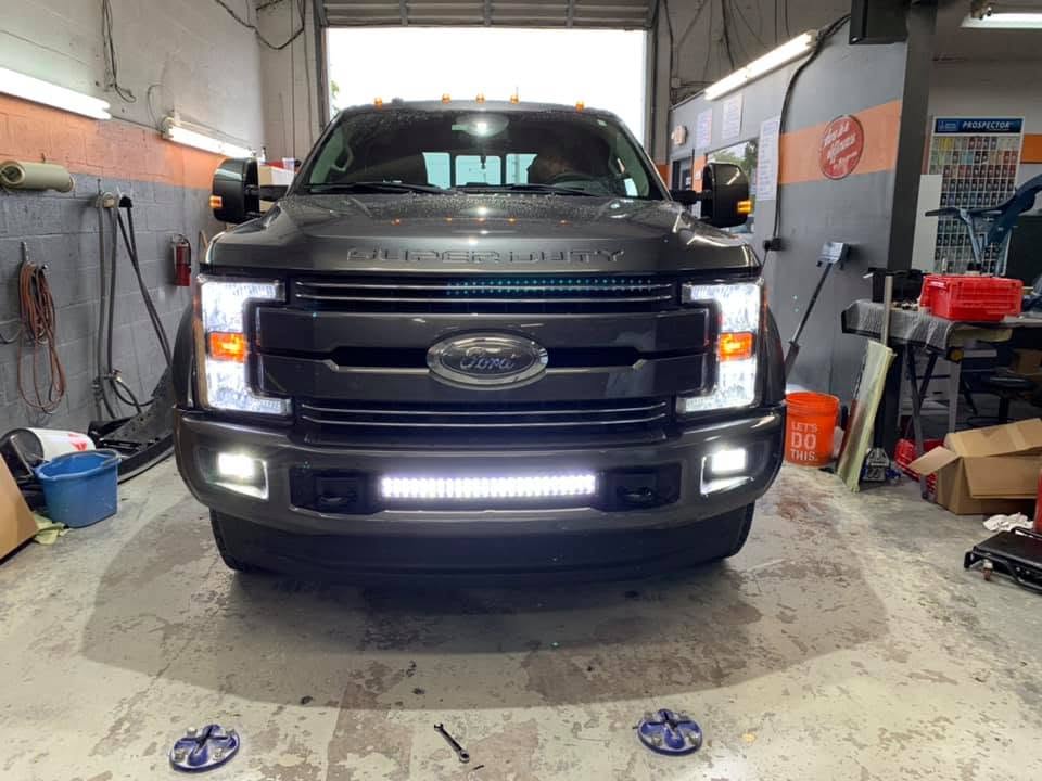 Ford Super Duty truck front-end collision repair at Automotive World Collision Center — before and after comparison